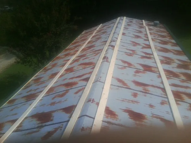 Rusted metal roof panels with new wood purlins before replacement — Storm Damage Roof Repair in Point Lookout by Roofing Brothers